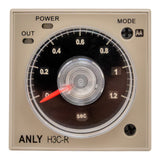 An analogue timer with a power and mode selection dial, marked with time ranges and an indicator needle, housed in a beige casing.