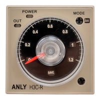 An analogue timer with a power and mode selection dial, marked with time ranges and an indicator needle, housed in a beige casing.