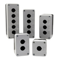 A group of five black and grey plastic push button enclosures with 'Signaworks' branding and various mounting holes on a white background