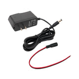 Angled perspective of a black power adapter with a secondary red and black cable on a white background.