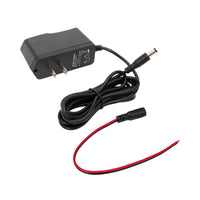 Angled perspective of a black power adapter with a secondary red and black cable on a white background.