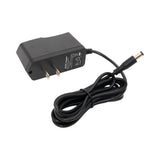 Black power adapter with cable on a white background