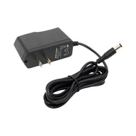 Black power adapter with cable on a white background