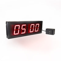 Digital timer with red LED display on a white background.
