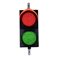 A 12 inch diameter LED traffic light with red and green lenses.