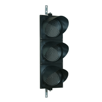 A 12 inch diameter triple lens LED traffic light mounted in a black housing with two steel right angle mounting brackets.